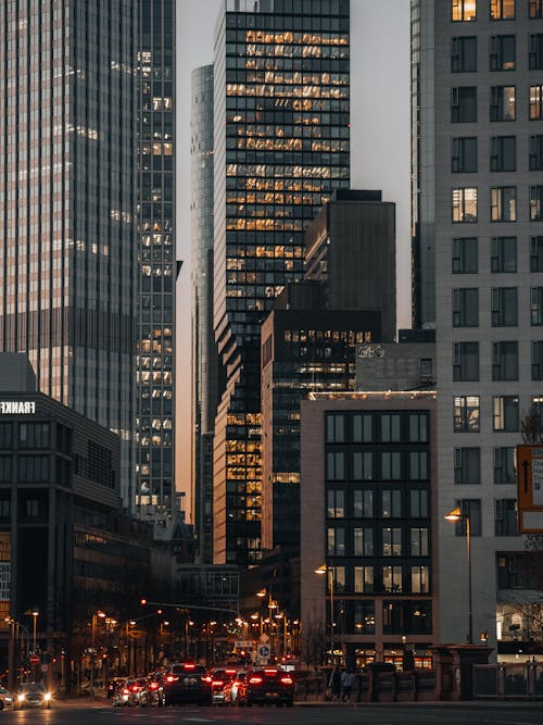 Cars and Skyscrapers in City in Evening