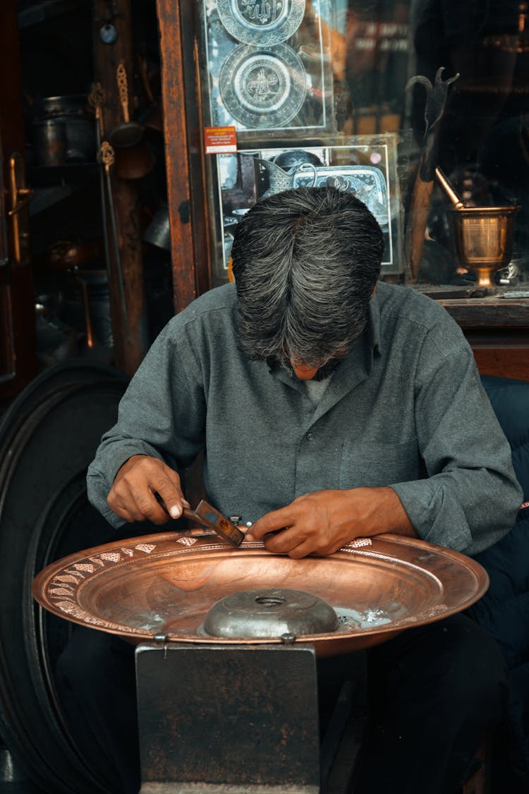 Craftsman Engraving Ornaments On A Brass Plate