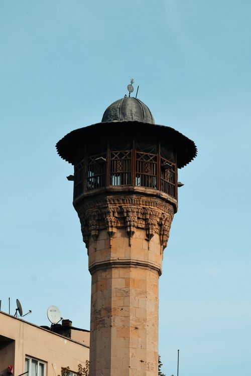 Free Vertical shot of a historic minaret in Turkey, showcasing Islamic architecture against the clear sky. Stock Photo