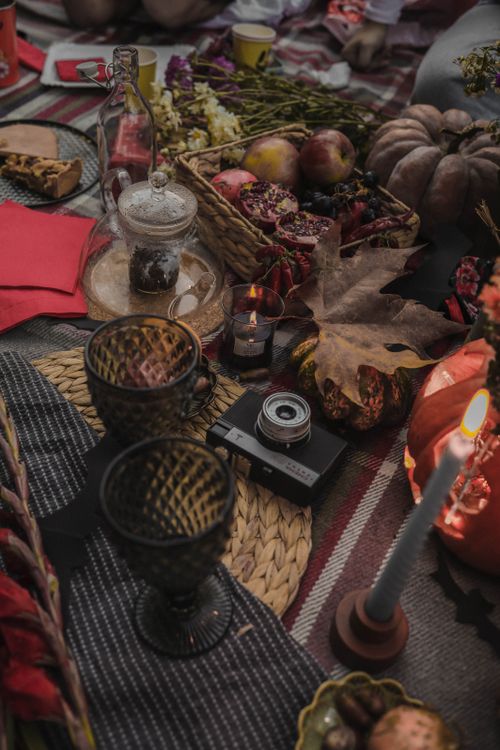 Free A cozy outdoor picnic scene with autumnal decor and fruits in a rustic setting. Stock Photo