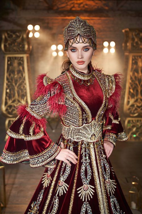Free Portrait of a woman in ornate traditional attire with rich embroidery and jewels. Stock Photo