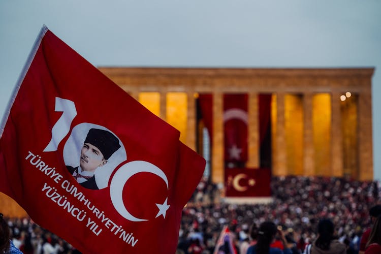 Turkish Flag With Mustafa Kemal Ataturk Over Crowd At Rally