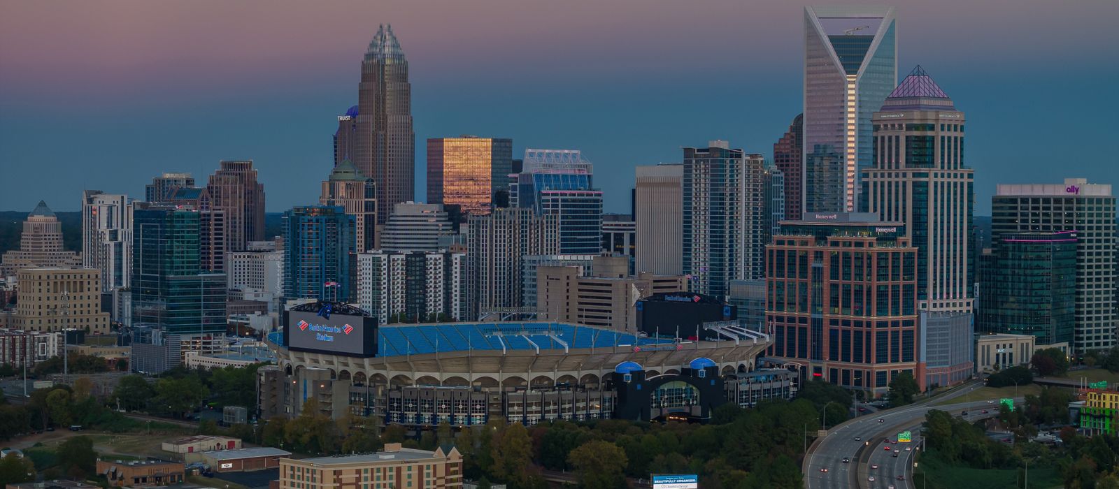 Aerial view of Charlotte skyline and Bank of America Stadium at dusk, North Carolina, USA.