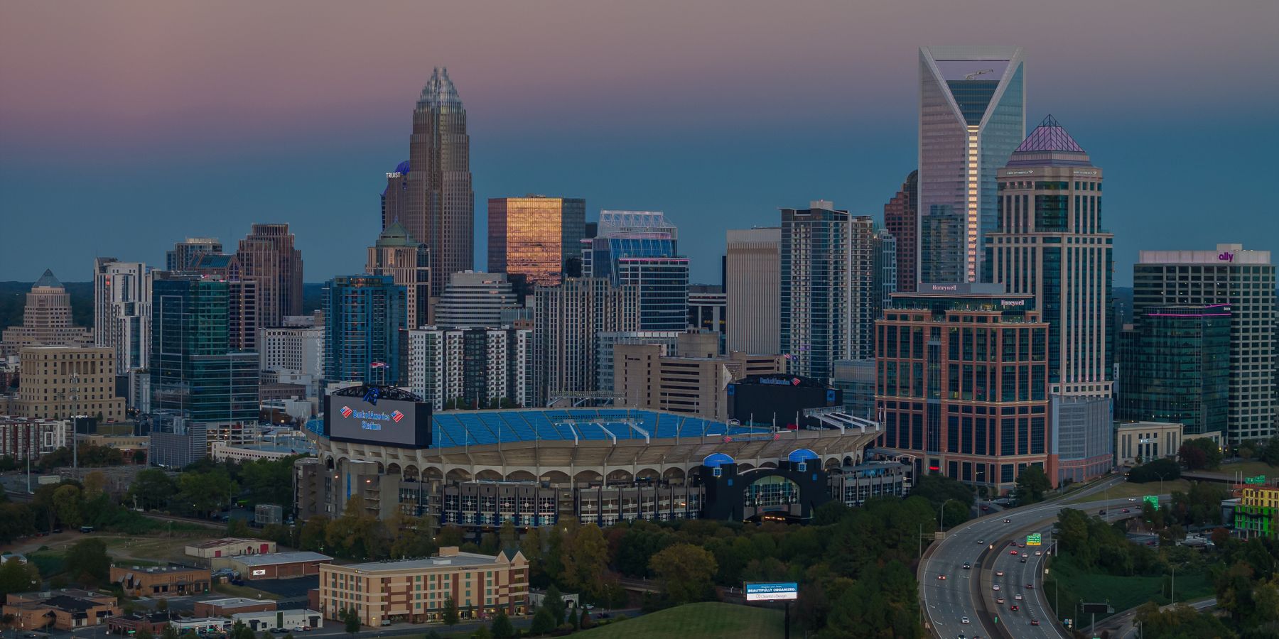 Aerial view of Charlotte skyline and Bank of America Stadium at dusk, North Carolina, USA.