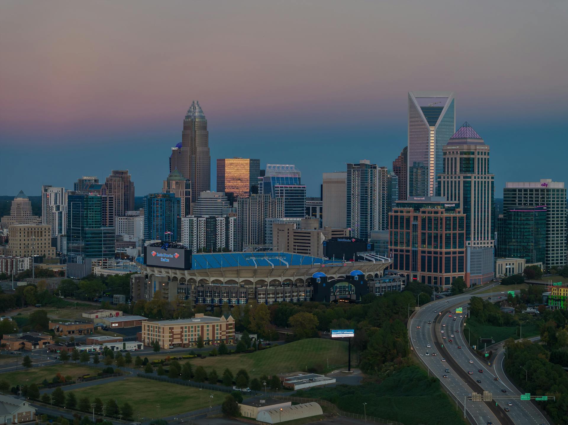 Aerial view of Charlotte skyline and Bank of America Stadium at dusk, North Carolina, USA.