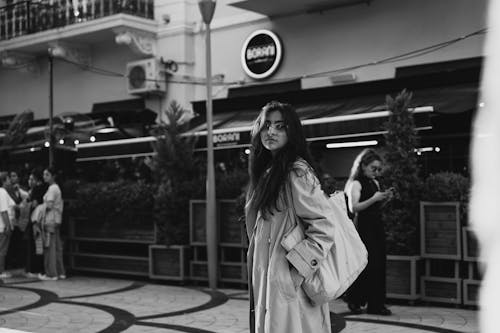 A woman walking down the street with a bag