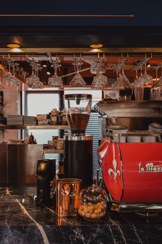 Elegant coffee shop interior featuring a sleek espresso machine and stylish glassware display.