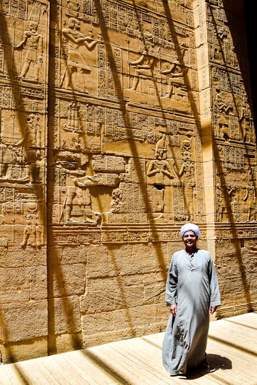 Man in Gown Posing by Wall in Luxor, Egypt