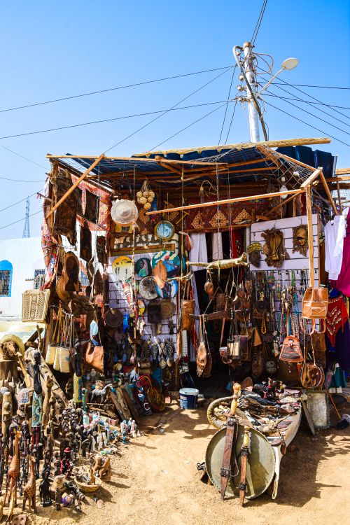 Free A vibrant display of handcrafted souvenirs at an outdoor market stall. Stock Photo