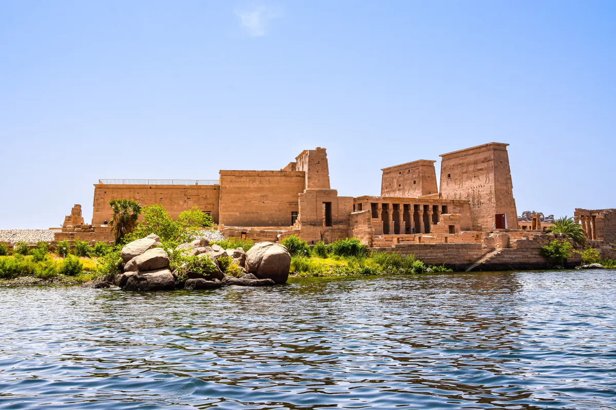 Ancient temple by the Nile River in Aswan seen on the dahabiya cruise