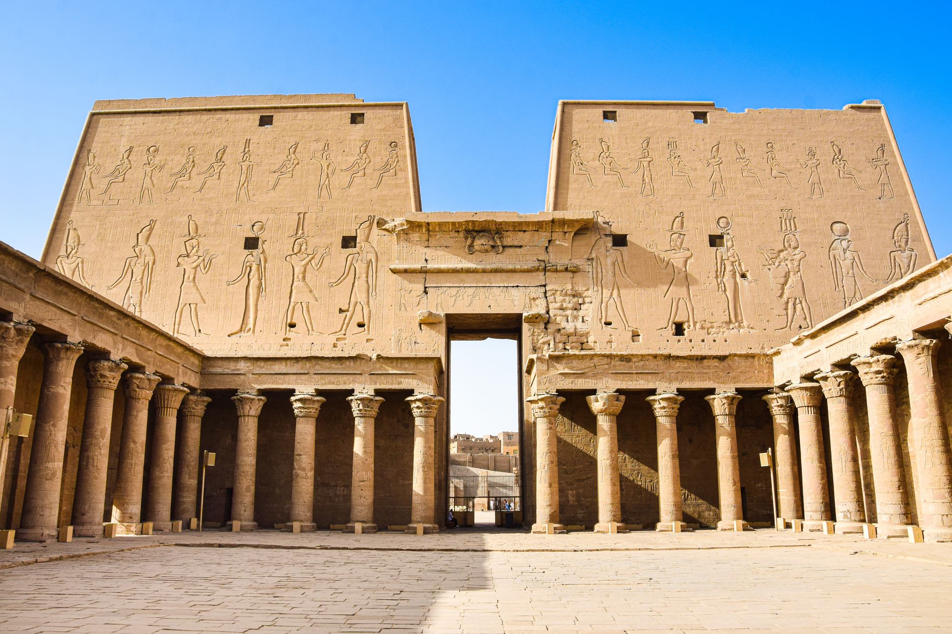 Explore the historic grandeur of ancient Egyptian ruins with towering columns and intricate carvings.