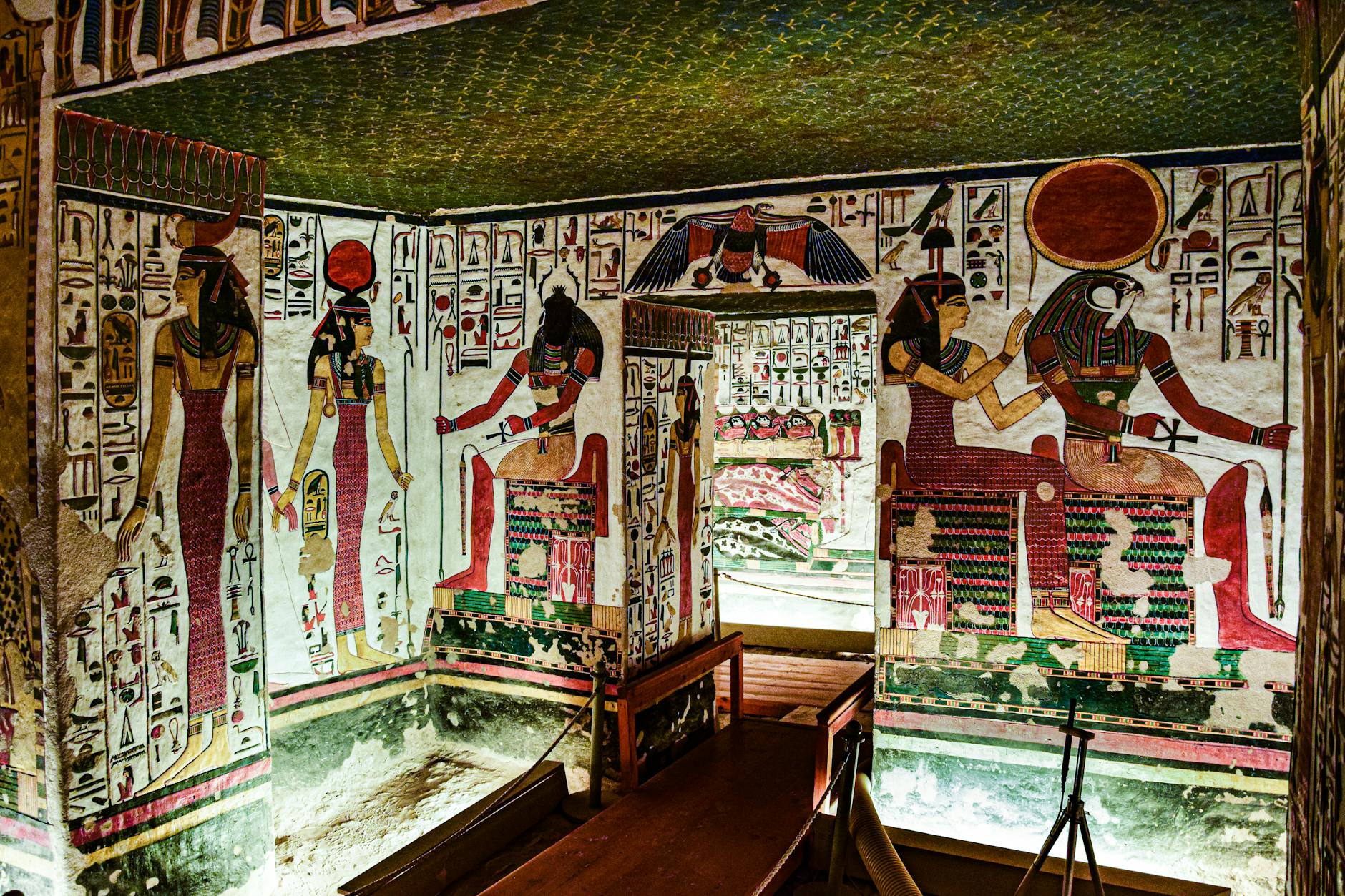 Colorful Egyptian murals depicting gods found inside an ancient tomb, rich in history.