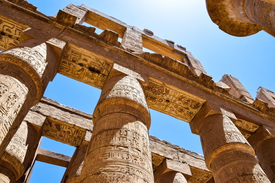 Close-up view of intricately carved columns at the Karnak Temple in Luxor, Egypt.
