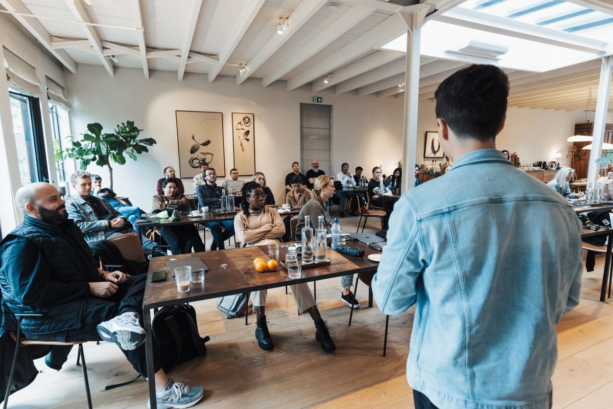 A team watching a business presentation on a screen in a modern conference room