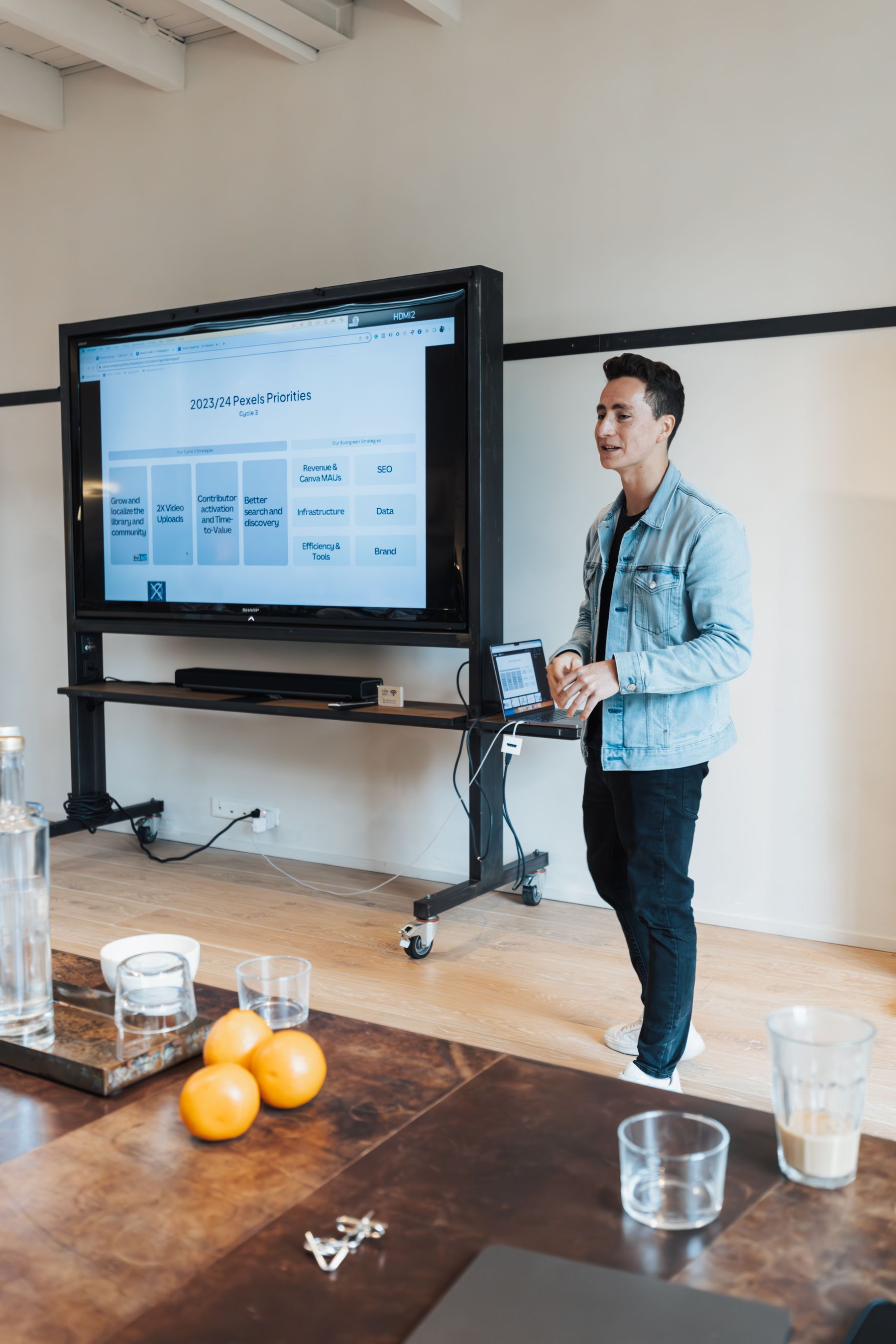 Business-casual professional presenting in a modern meeting room