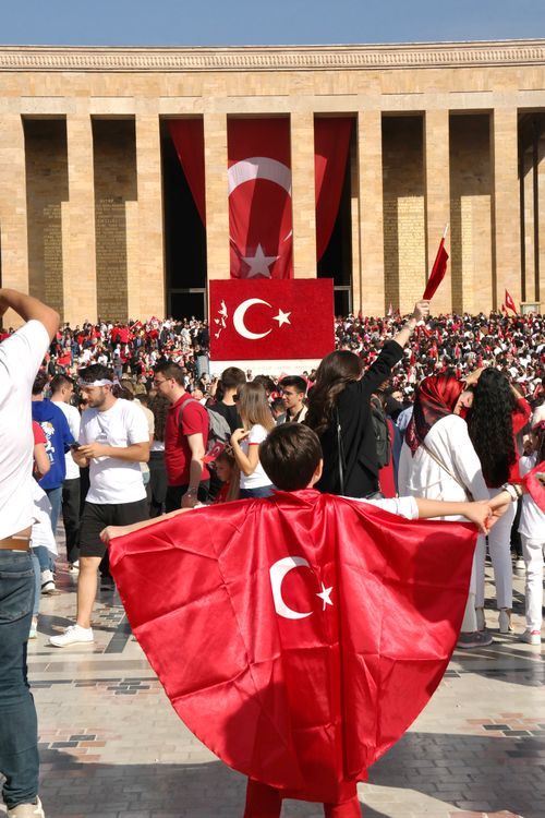 Free Crowd gathers at Anitkabir, Ankara, with Turkish flags, celebrating national pride. Stock Photo