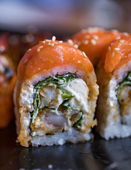 Free Mouth-watering sushi roll with salmon, rice, and sesame in a close-up shot. Stock Photo
