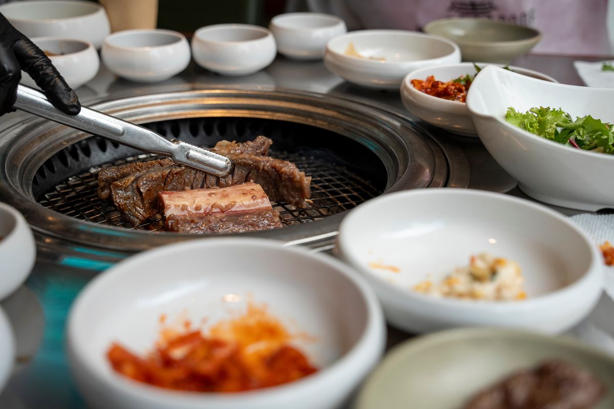 Traditional Korean BBQ grilling with assorted side dishes