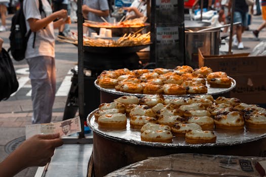 Explore the bustling street food scene in Seoul with delicious pastries on display.