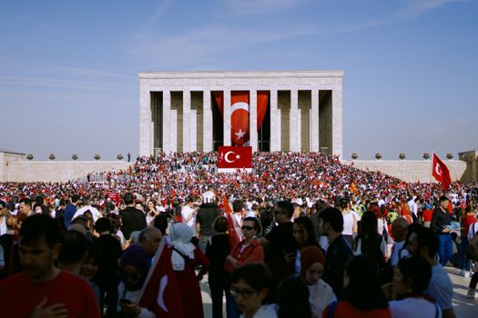 Large crowd gathered with Turkish flags at Anıtkabir, Ankara celebrating a national event.