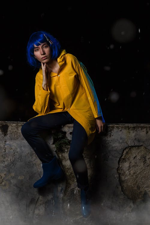 Woman in Yellow Shirt and with Blue Hair at Night