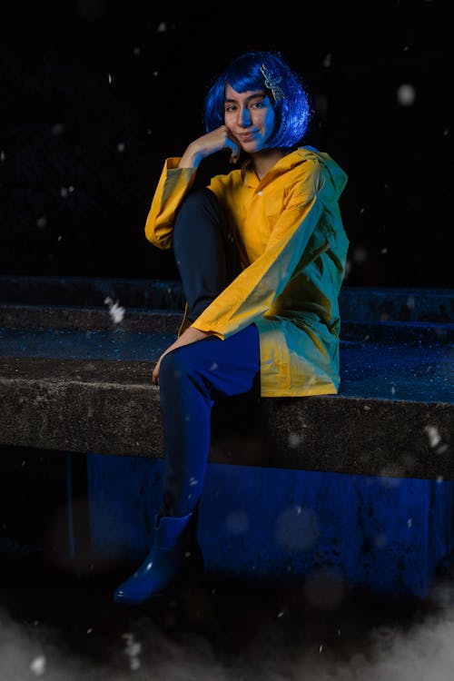 Woman with Blue Hair Wearing Yellow Jacket 