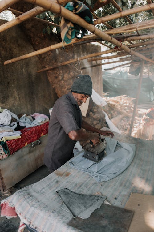 Man Ironing with Charcoal Iron