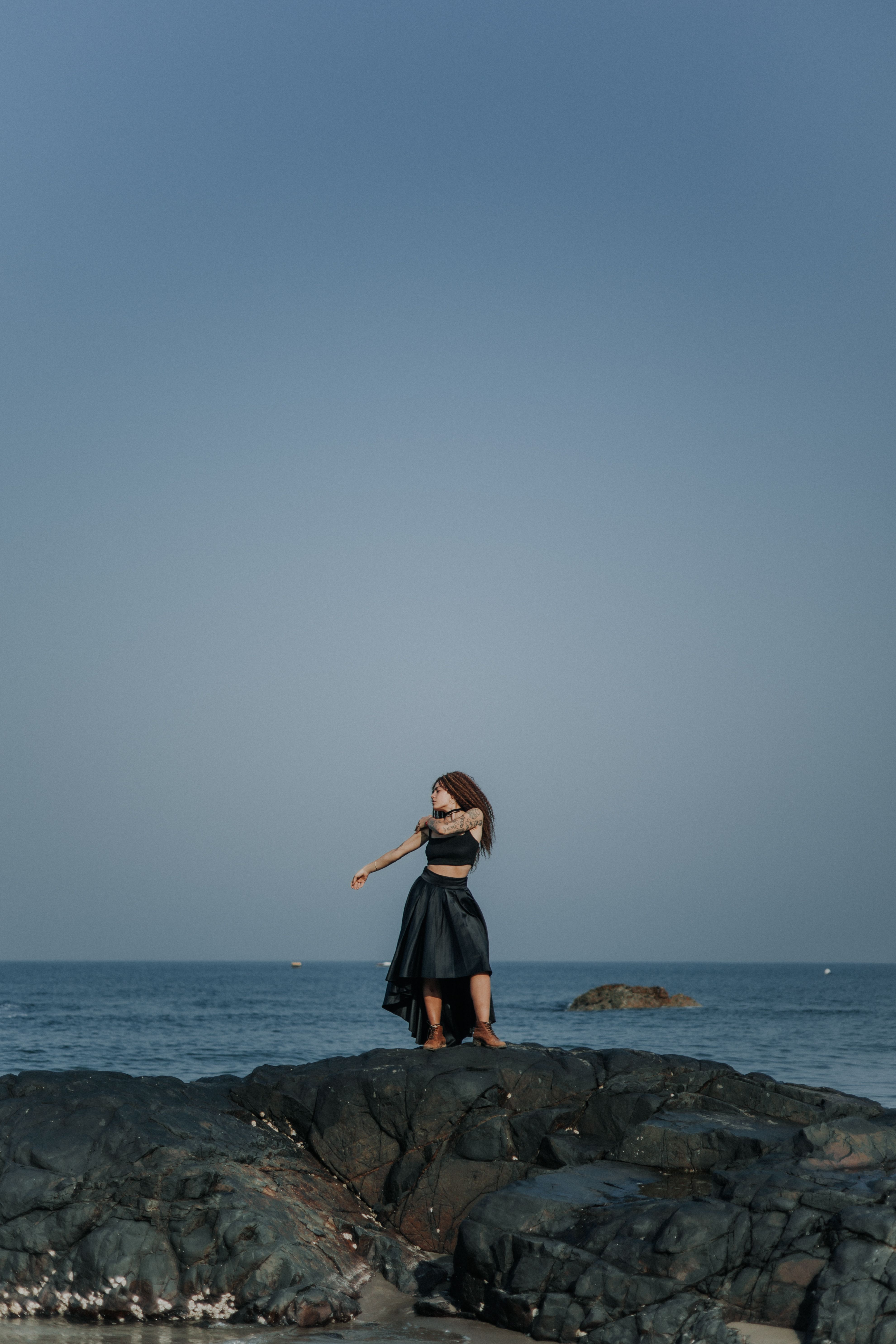 Woman Posing in Black Dress on a Beach · Free Stock Photo