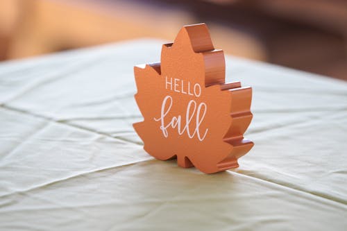 Close-up of a Decoration in a Shape of a Leaf with a Sign "Hello Fall"
