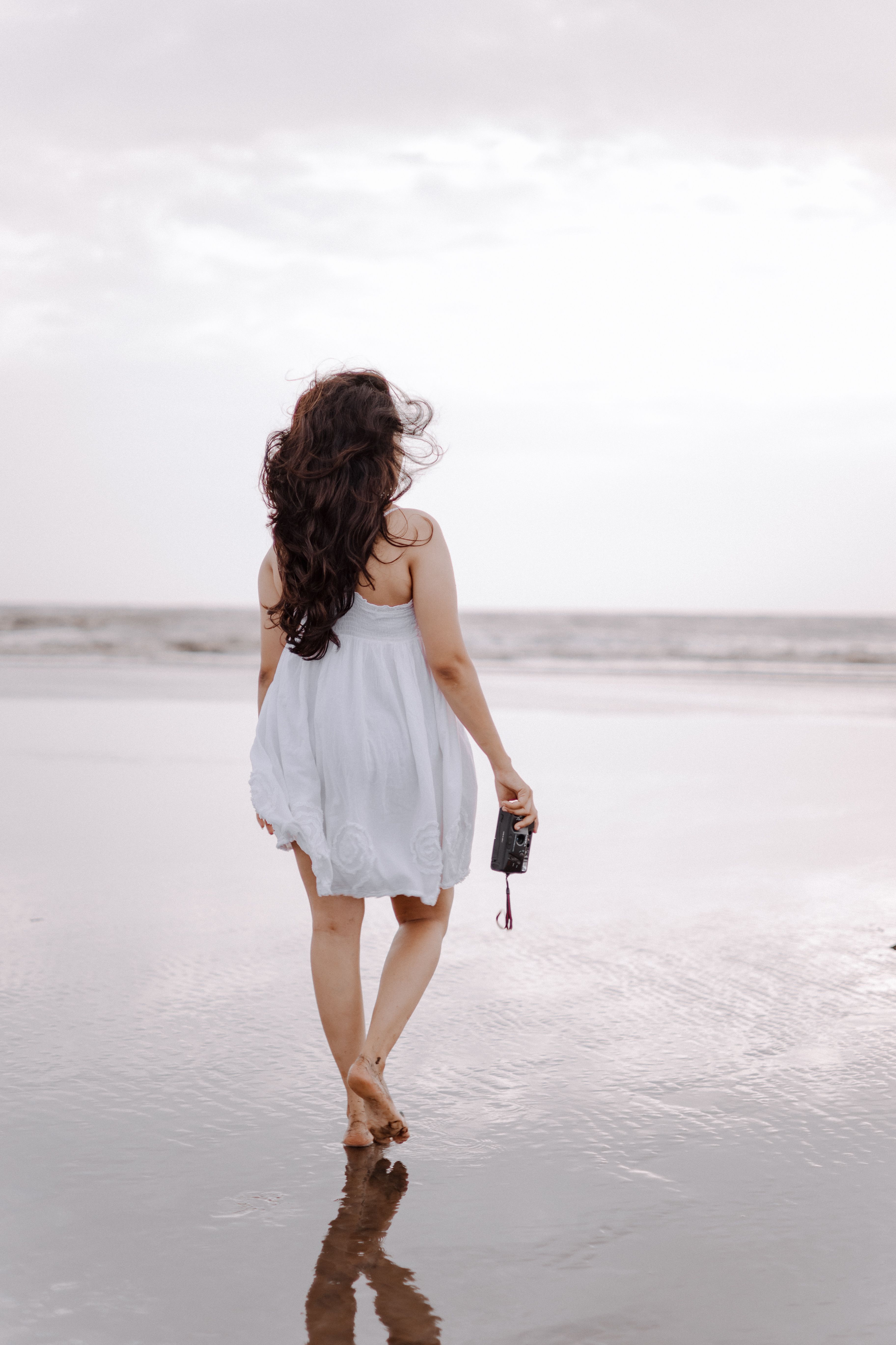 Woman in a White Dress Walking on a Beach · Free Stock Photo