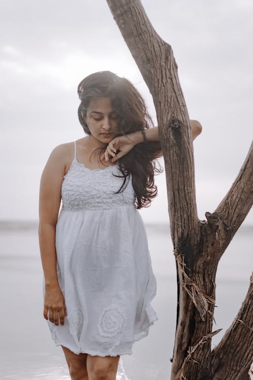 Woman in White Dress Standing by Withered Dress