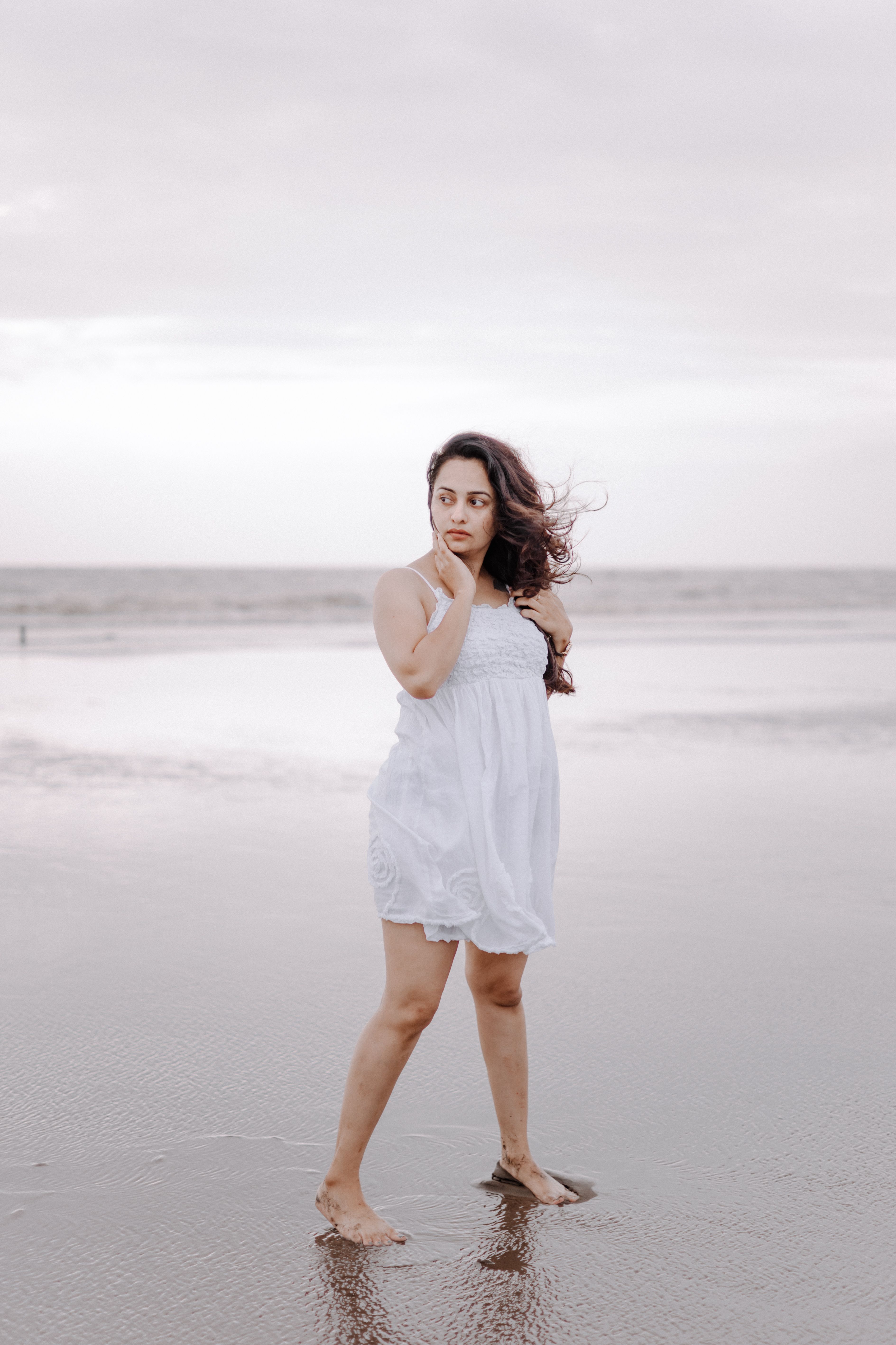 Woman in a Dress Standing on a Beach · Free Stock Photo