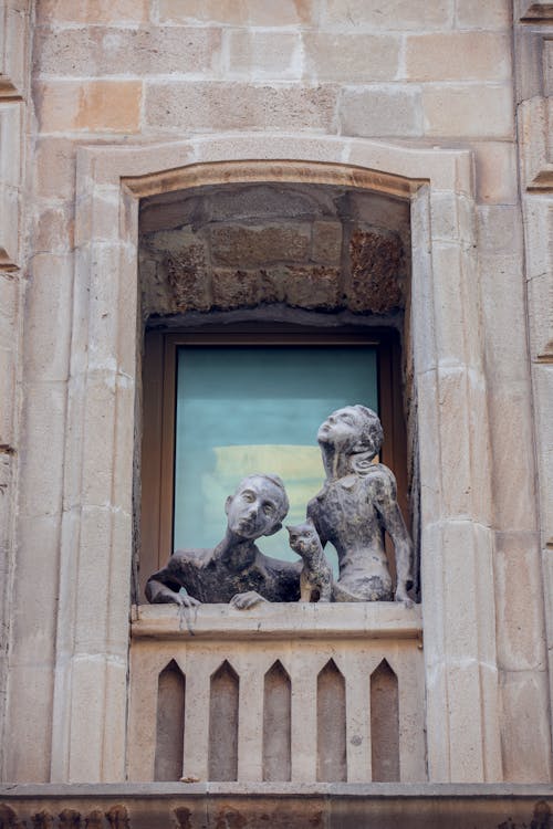 Sculpture of a Couple with a Cat on a Balcony 