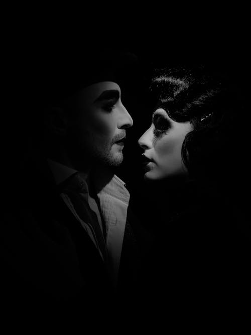Black and White Shot of a Man and Woman in Vintage Costumes