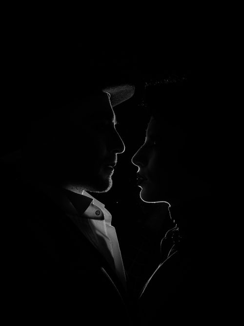 Free A striking black and white silhouette of a man and woman face to face. Stock Photo