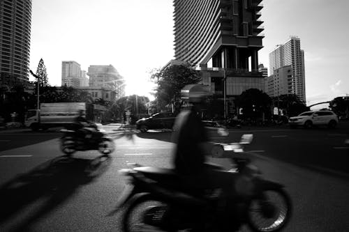 Cars and Motorbikes on Street at Sunset in Black and White