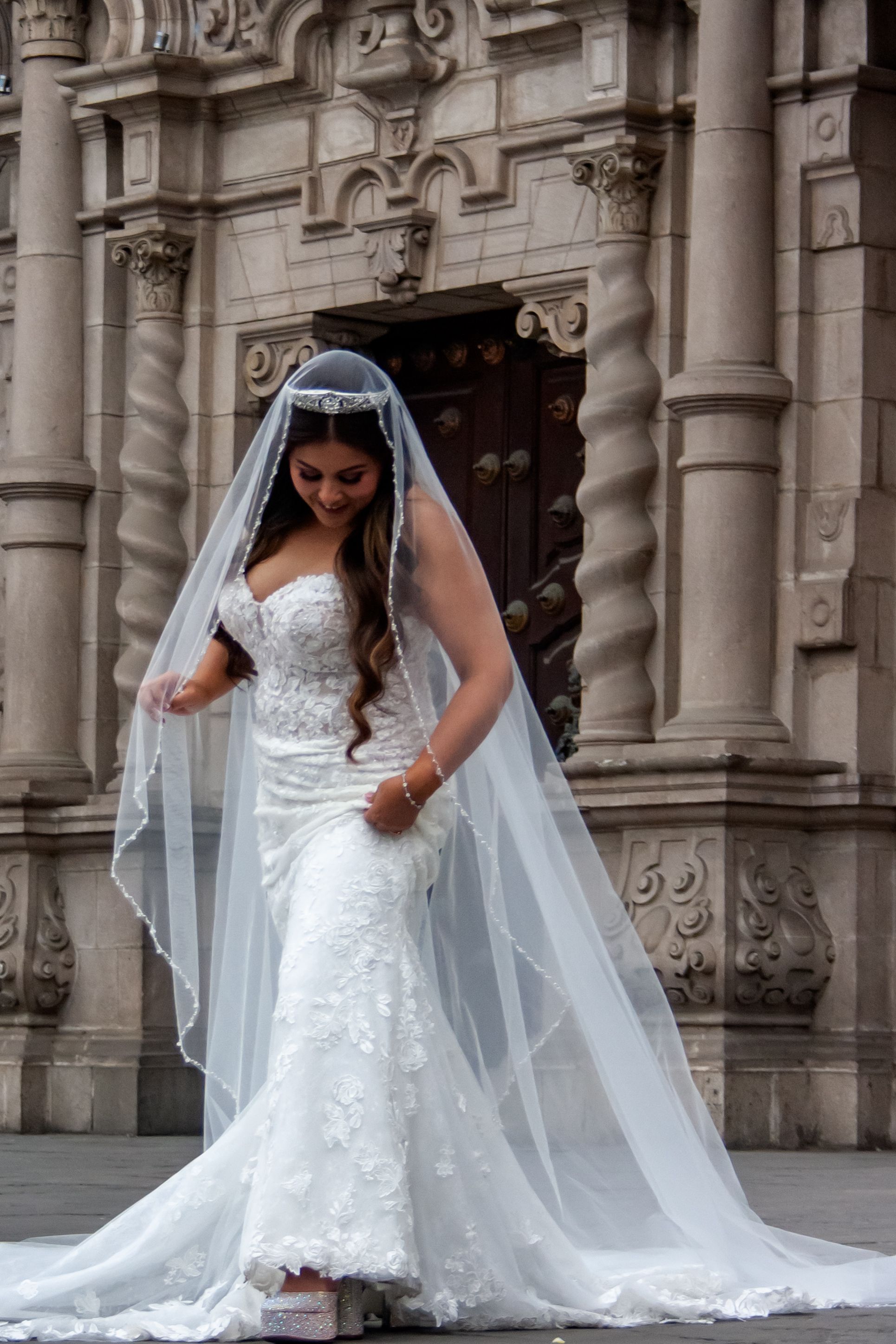 Bride in a White Wedding Gown with Veil Posing by Lima Cathedral · Free ...