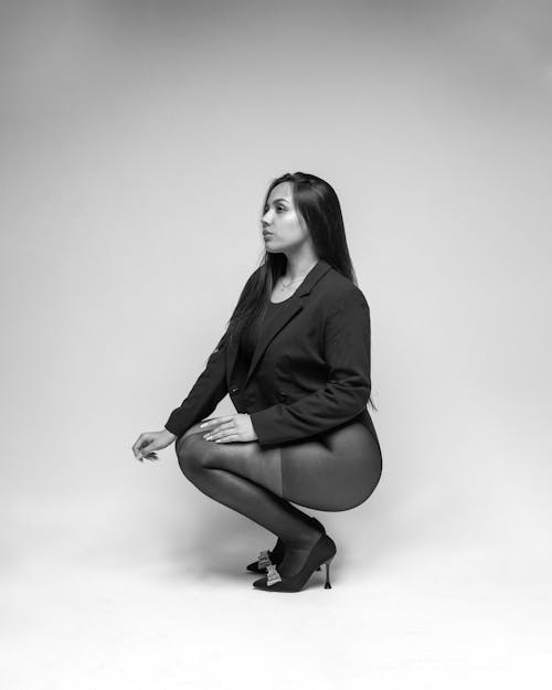Woman Squatting and Posing in Black and White
