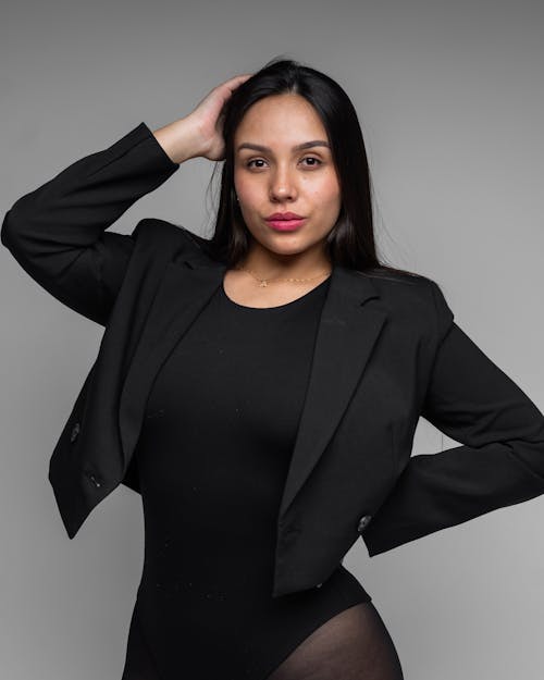 Brunette Woman Posing in Black Cropped Blazer and Bodysuit