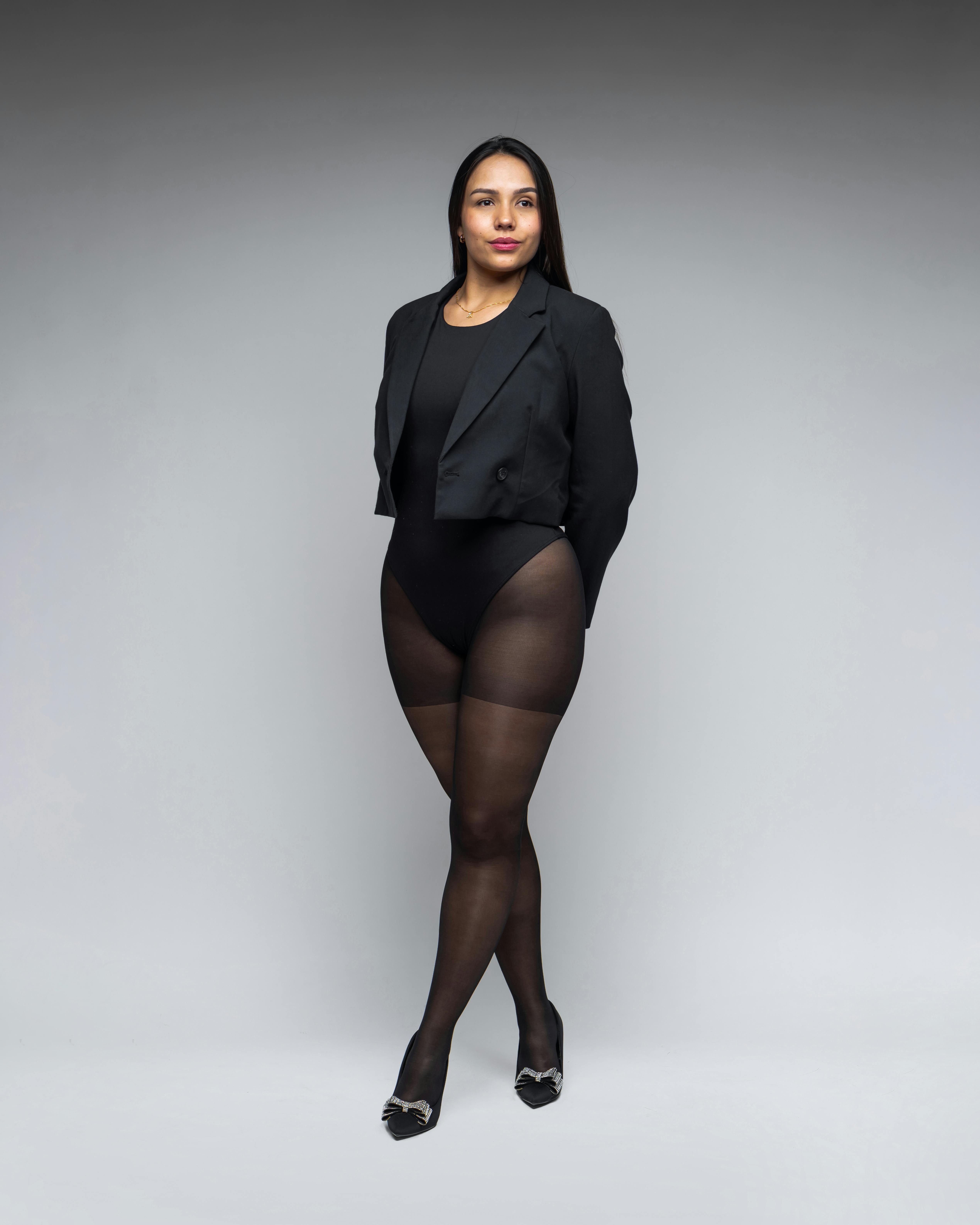 Brunette Woman Posing in Black Cropped Blazer, Bodysuit, and Tights · Free  Stock Photo