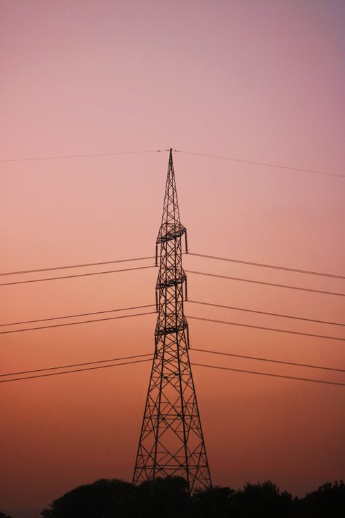 Free Silhouette of a transmission tower against a vibrant sunset sky in Pakistan. Stock Photo