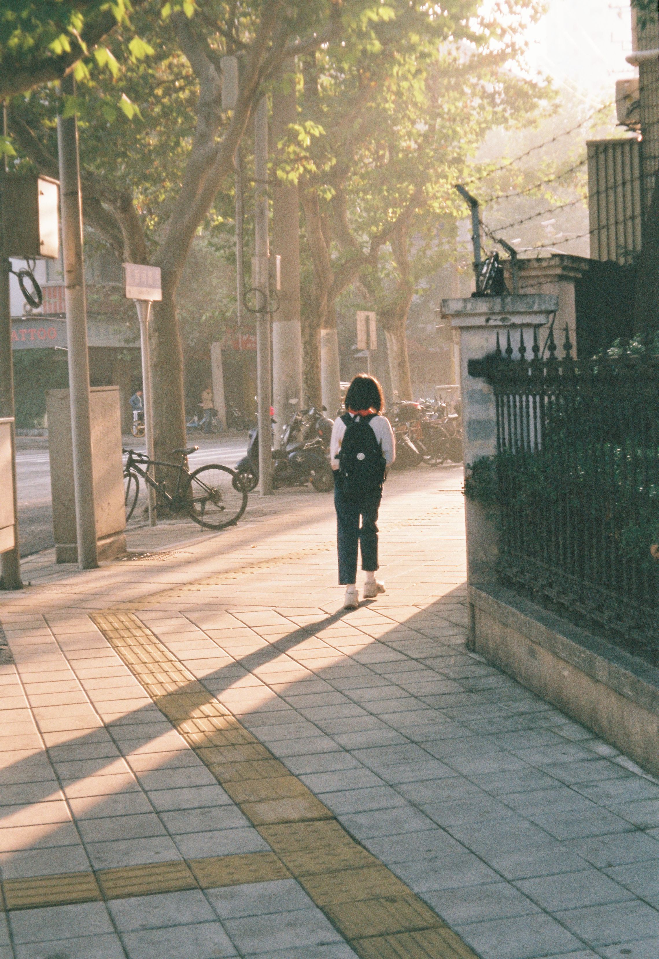 Teenager Girl with a Backpack Walking on a City Street at Sunrise ...