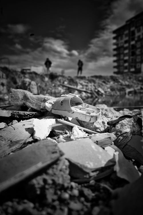 Sandal Lying on a Pile of Rubble after an Earthquake