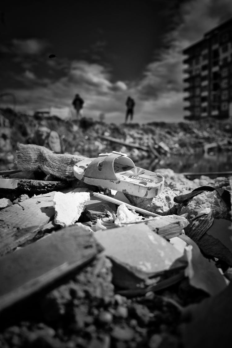 Sandal Lying On A Pile Of Rubble After An Earthquake