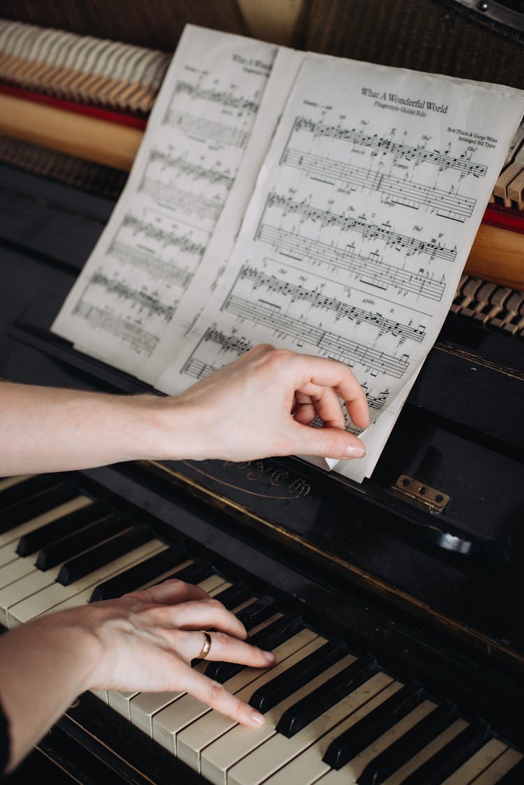 Turning Pages Of Sheet Music While Playing The Piano