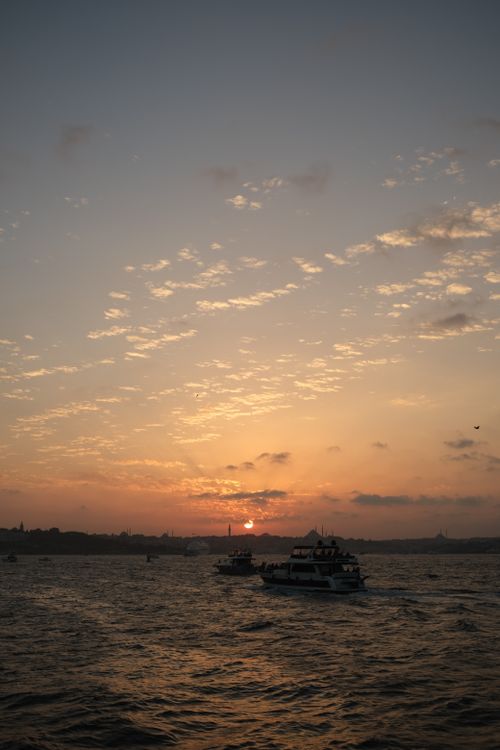 Free Mesmerizing sunset view of ferries sailing on the Bosphorus strait in Istanbul, Turkey. Stock Photo