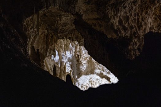 Explore the stunning rock formations inside a majestic cave with intricate textures.