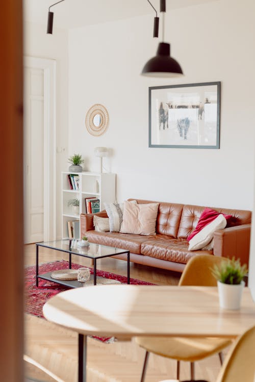 Living Room with Brown Leather Sofa and Glass Coffee Table