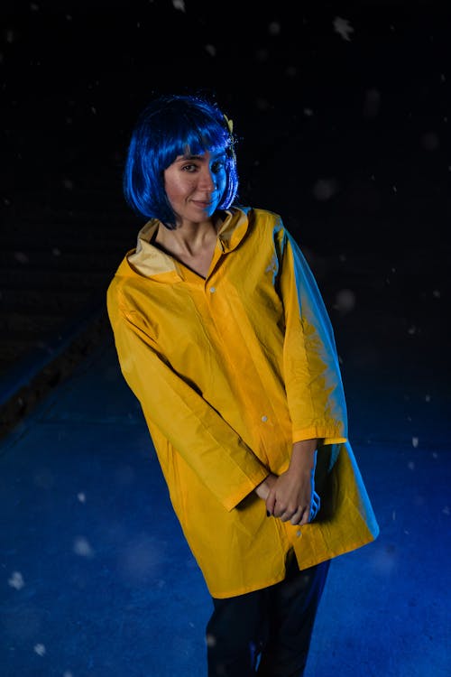 Woman with Blue Hair and in Yellow Shirt at Night