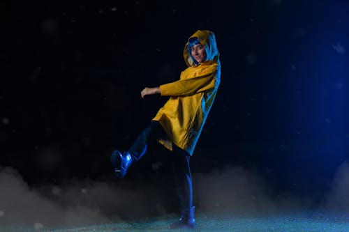 Smiling Woman in Yellow Clothes at Night
